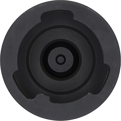 Dunkelgrauer Metallgegenstand mit runder Form und mehreren konzentrischen Kreisen und Aussparungen.